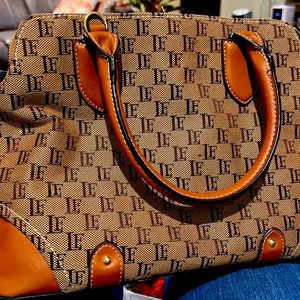 London Fog bag,  two handles.  Three sections each with a working zipper.